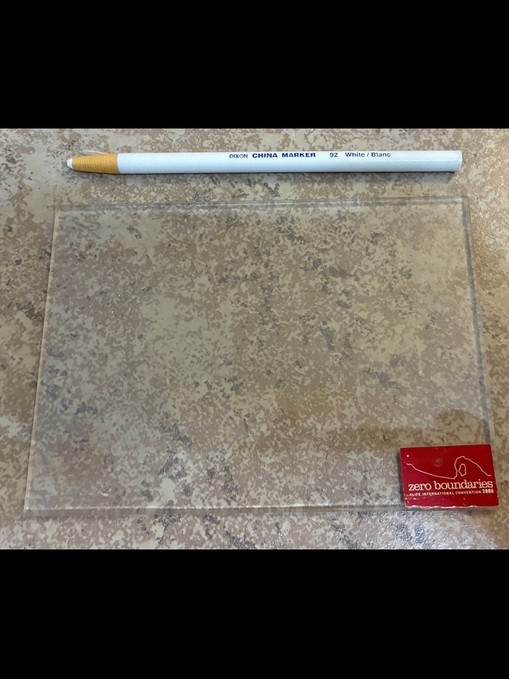 Clear rectangular acrylic sheet alongside a Dixon China Marker 92 white pencil.
